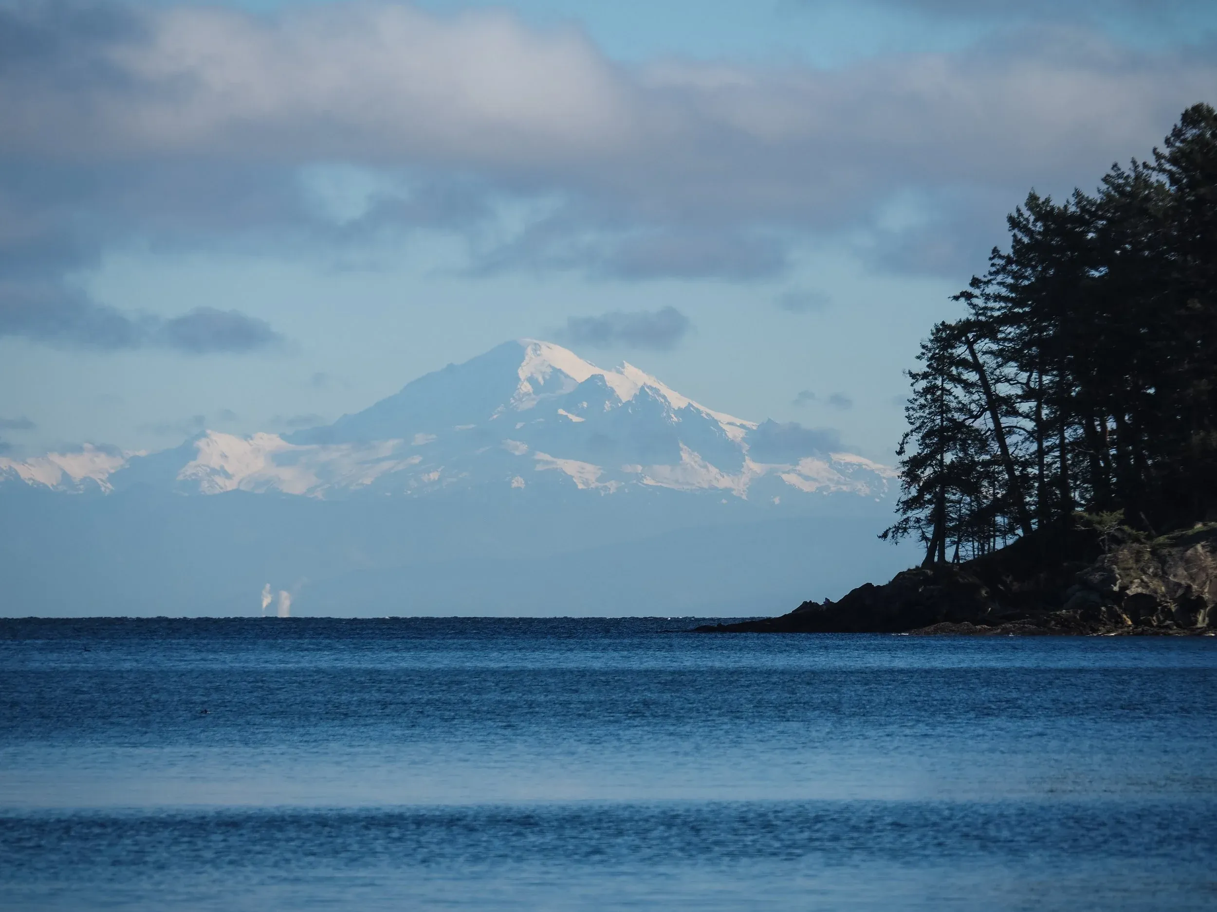 Mt. Baker towers above much of the region, with an enormous prominence. View across Georgia Straight from the Gulf Islands. From this photo I would guess the Coleman-Deming Col is just to the right of the little nub down and left from the summit.