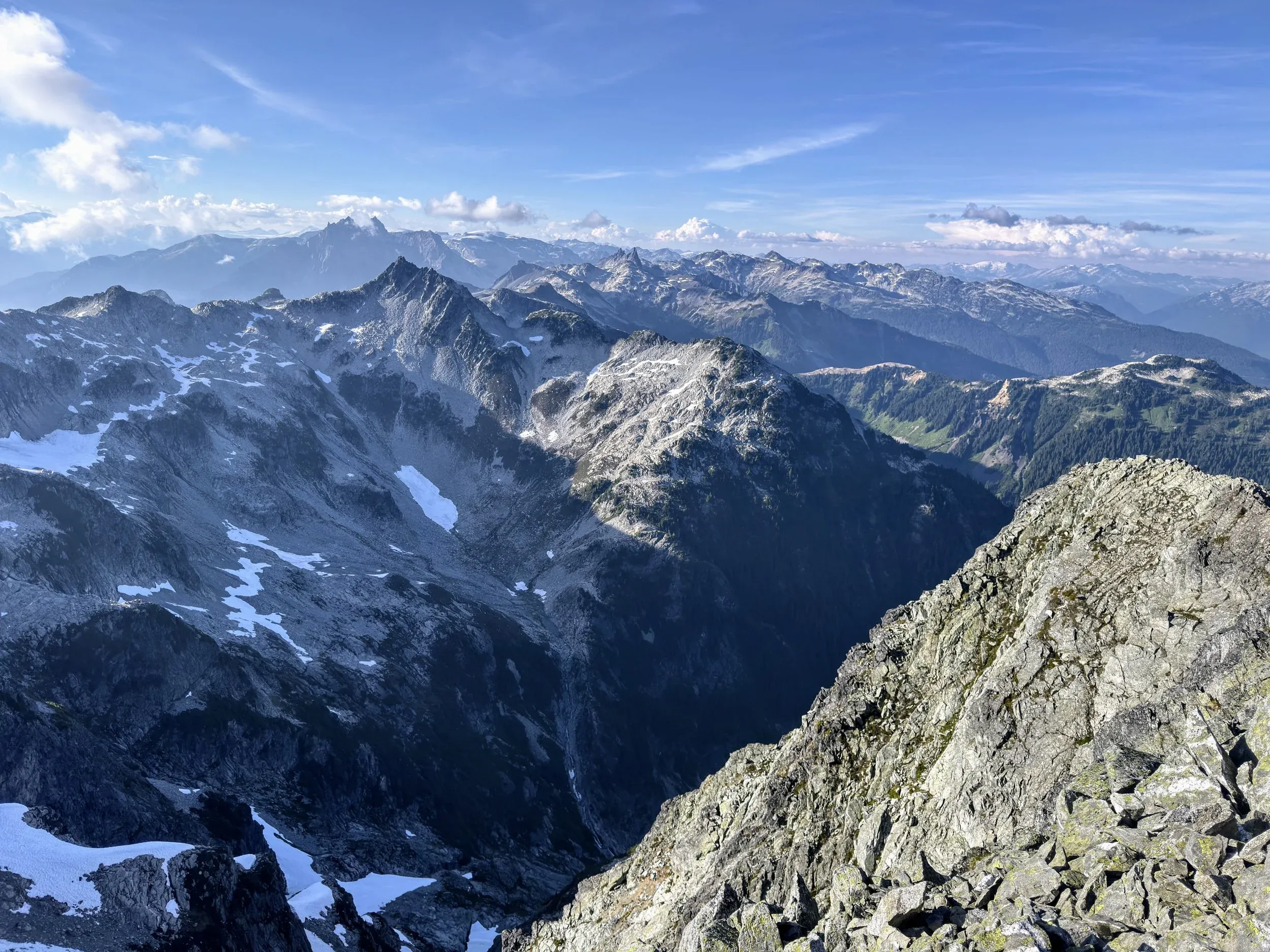 View of the route back from Tricouni. Cypress is the smaller triangle on the ridge on the left, the two teeth of Fee near the middle, and the far ridge dropping to the right is Brandywine.