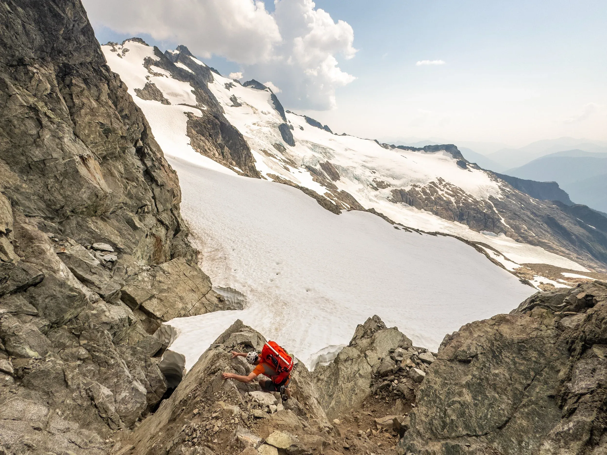 Descending down on the far side of the previous climb onto the next snow slope, where you ascend high to the left to finally gain the proper Tantalus Ridgeline